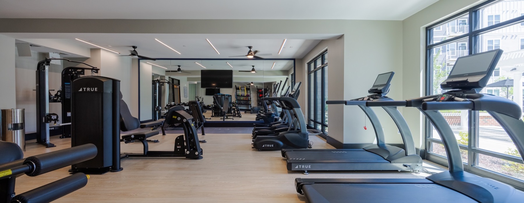 Madison Ironbridge fitness center with treadmills, strength machines, and large windows.
